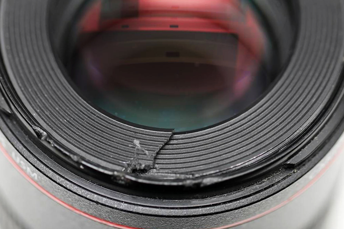 Camera lens with a cracked filter after an accidental drop